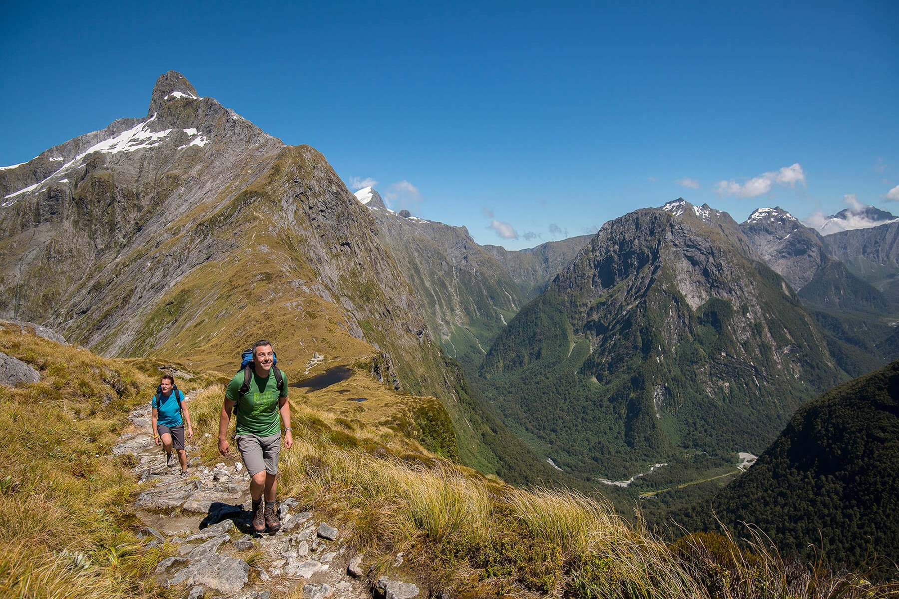 Hikers leaving Mackinnon Memorial - Milford Track guided walk