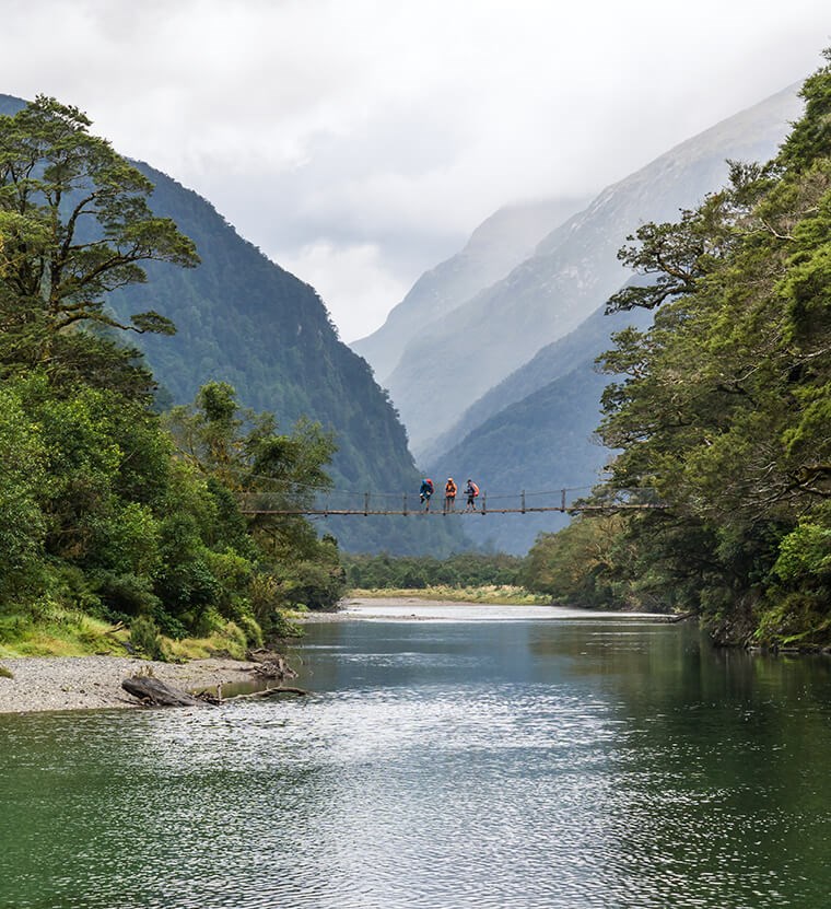Crossing the bridge past boatshed - Milford Track guided walk