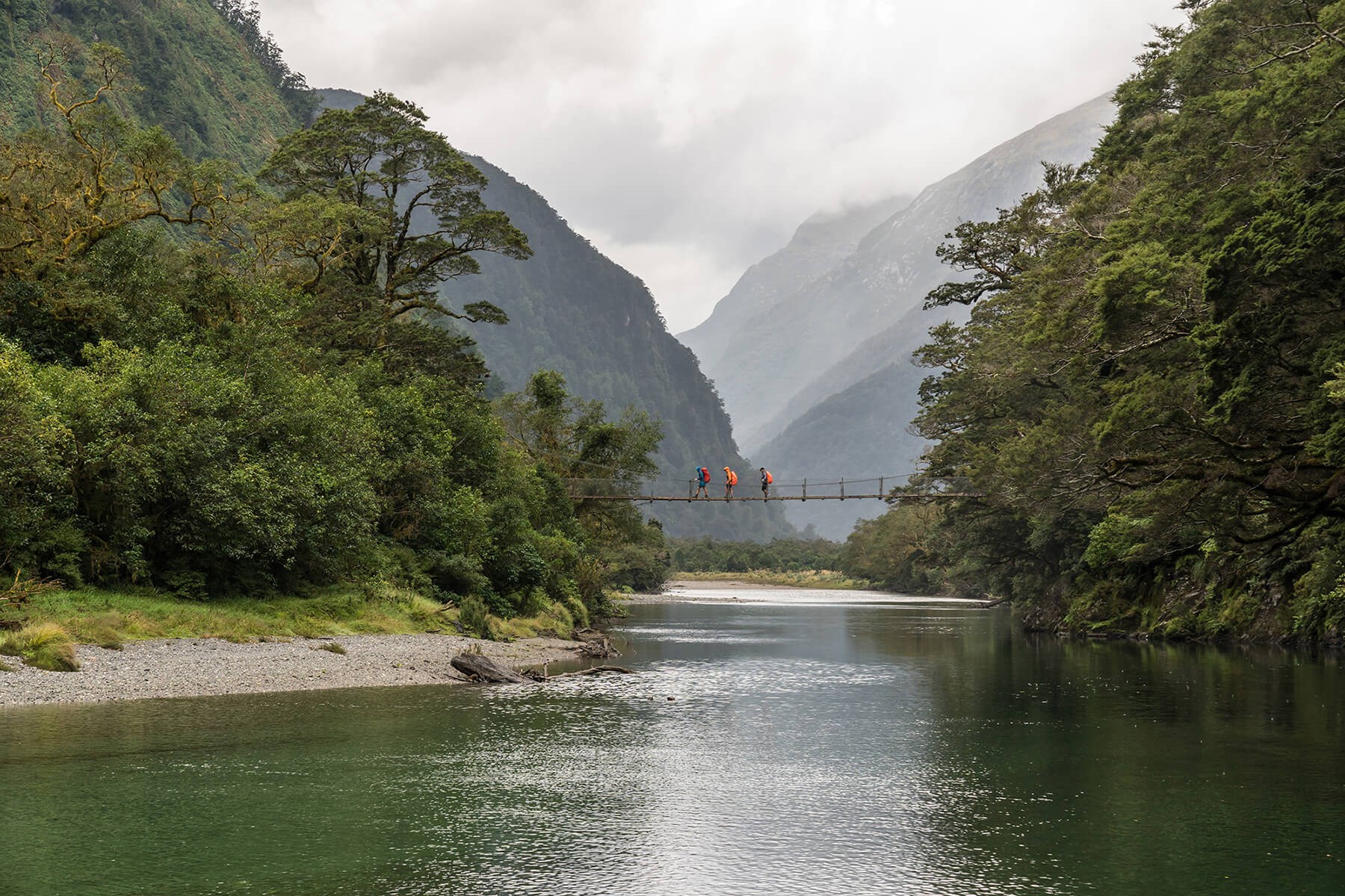 Crossing the bridge past boatshed - Milford Track guided walk