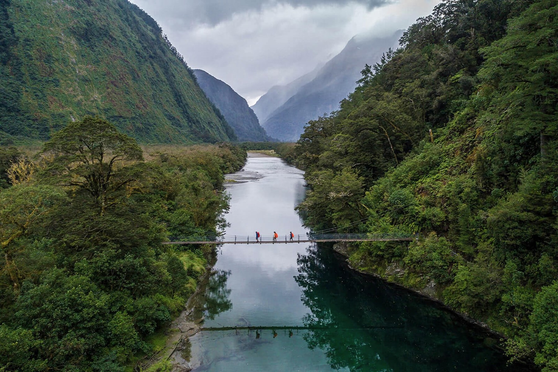 Crossing the bridge past boatshed - Milford Track guided walk